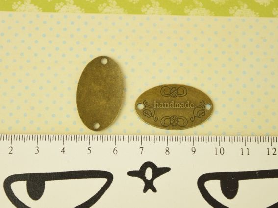 Бирка Hand Made металева Овал 31х18 мм колір антична бронза, розмір 25х6 мм